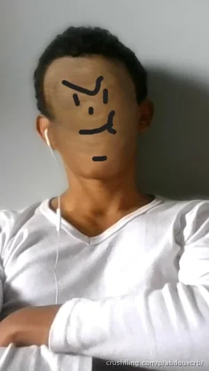 person in white long-sleeve shirt with face drawn over, indoors