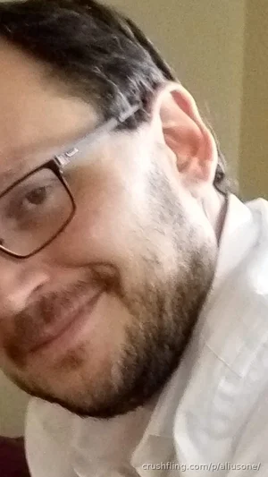 man with beard and glasses wearing white shirt, indoor selfie