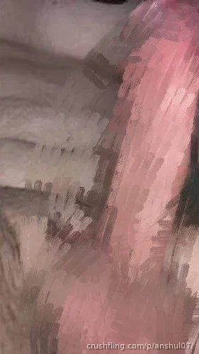 Blurred image of a person in pink clothing, possibly in a bedroom setting.