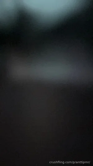 Blurred dark image with no clear person or object visible.