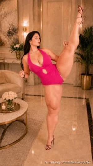 Woman in pink one-piece swimsuit posing indoors, leg raised, in a luxurious room.