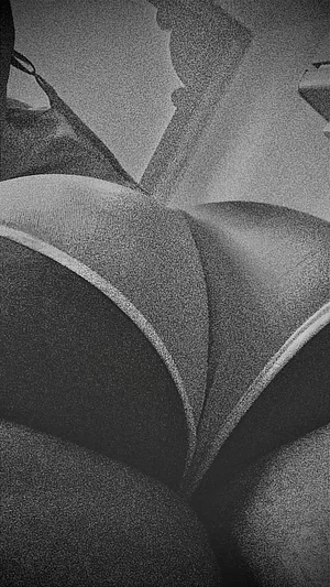 Close-up of person in dark underwear with white trim, showing lower back and buttocks.