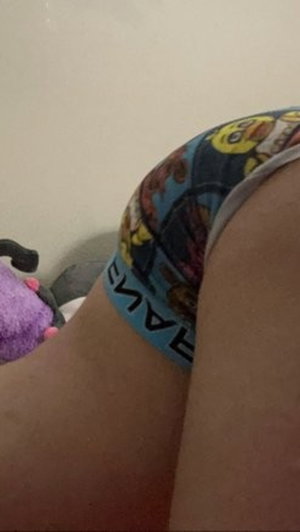 Person wearing colorful underwear, legs visible, indoor setting.