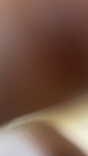 Blurry image with no discernible person or details.