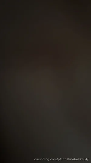 Blurred dark image with no discernible person or setting.