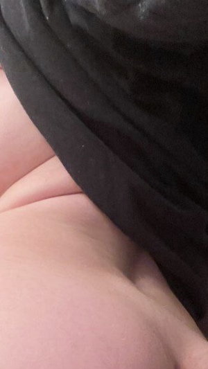Close-up of skin and black fabric, possibly clothing or lingerie.