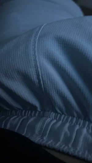 Close-up of light blue fabric, possibly underwear, with elastic waistband.