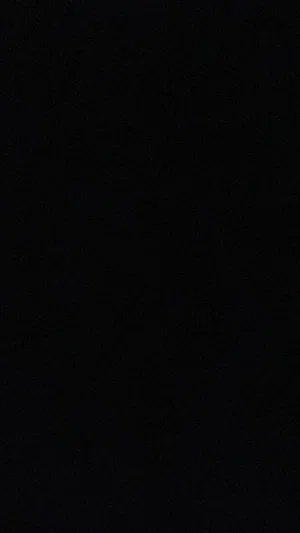 Solid black image with no visible content or person.