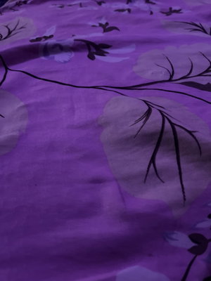 Close-up of purple floral patterned fabric.