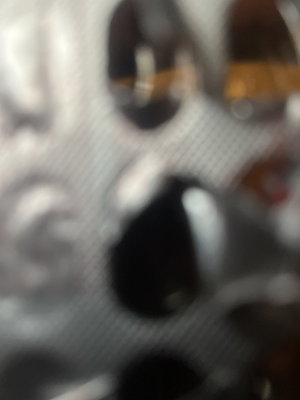 Blurred close-up of a blister pack with capsules.