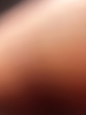 Blurred close-up of skin tone, no identifiable features or context.