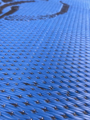 Close-up of blue woven textured mat surface.