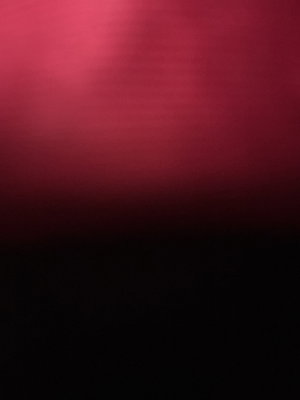 Solid red to black gradient background.
