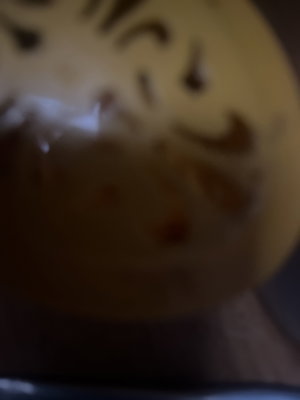 Blurry close-up of yellow bowl with brown swirls.