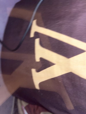 Dark fabric with large yellow LV logo and cord.