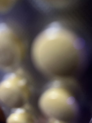 Blurry close-up of round beige objects.
