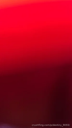 Blurred red image with no discernible person or setting.