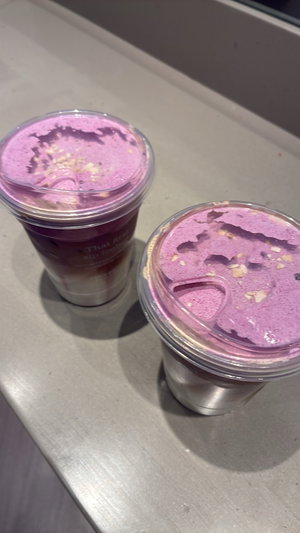 Two purple drinks on gray counter.
