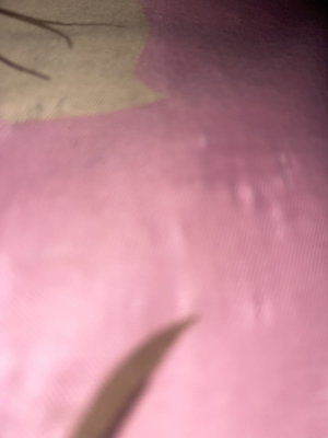 Close-up of pink fabric with leaf pattern.
