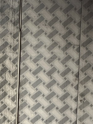 Gray and white patterned wall with vertical lines.
