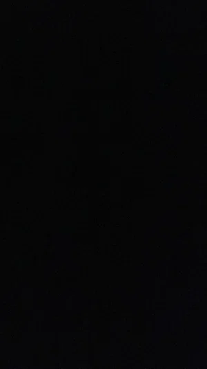Solid black image with no visible content or person.