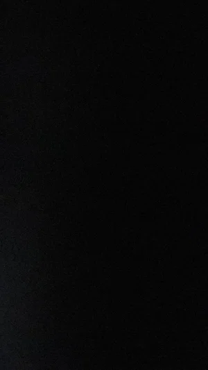 Solid black image with no visible content or person.