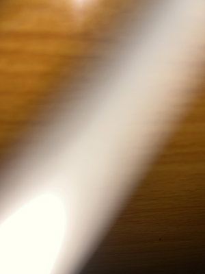 Blurry wooden surface with light reflection.