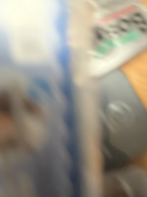 Blurry close-up of packaging and objects on a surface.