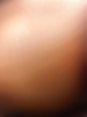 Blurry close-up of skin with warm lighting.