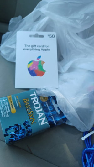 No person; Apple gift card and Trojan condoms on car seat.