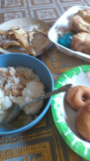 Table with fried chicken, rice, doughnuts.