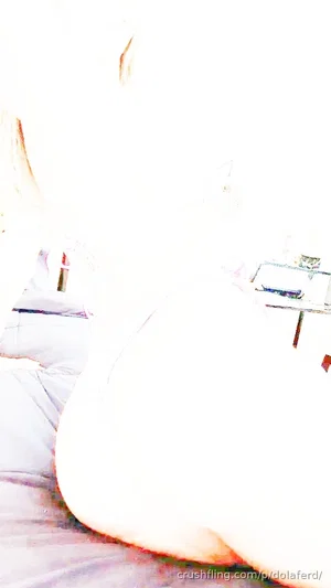 Overexposed image of a person lying on a bed, body mostly obscured by bright light.