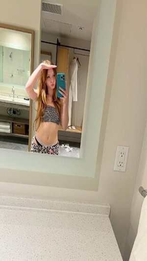 Redhead in bandeau top and leopard panties in bathroom mirror selfie.