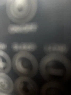 Blurry close-up of electronic device with buttons.