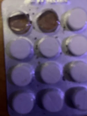 Blister pack of round pills with some missing.