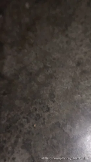 Dark, blurry surface with no visible person or object.