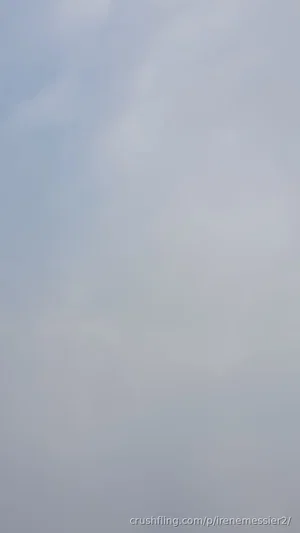 Blurred sky with soft clouds, no visible person or object.
