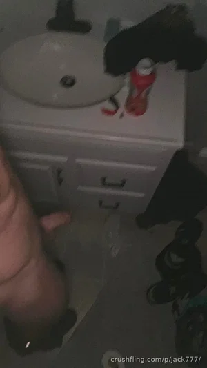 Hand visible near bathroom sink with toiletries and shoes on floor.