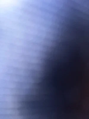 Blurred abstract image with blue and white gradients, no person visible.