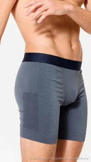 Man in gray boxer briefs, showing back and waist, standing against white background.