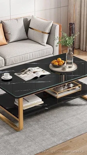Modern living room with black marble coffee table, gray sofa, and decor.