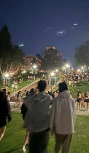 Crowd at nighttime UCLA outdoor event on stairs.