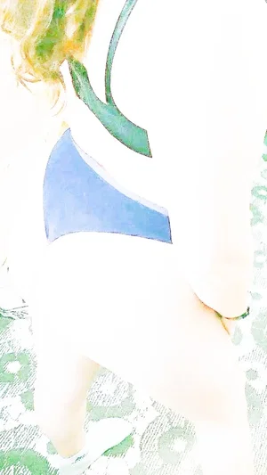Woman in blue top with green straps, partially visible, wearing patterned green bottoms.
