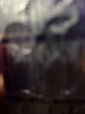 Blurry close-up of fishnet clothing on a person.