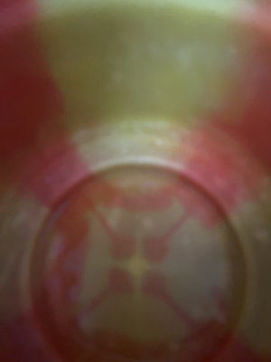 Blurry red and yellow patterned circular object.