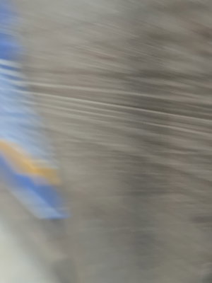 Blurred motion shot with blue and yellow streaks.