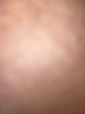 Blurred close-up of skin tone, no distinct features visible.