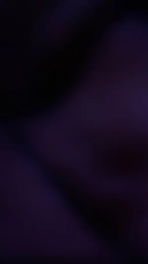 Blurred dark image with no clear person or object visible.