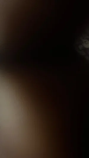 Blurred image with indistinct shapes, no clear person or setting visible.