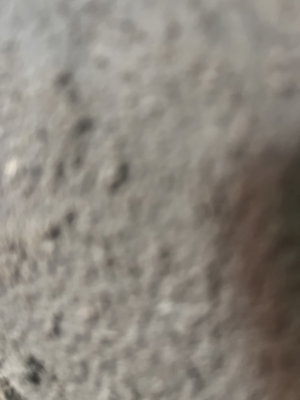 Blurry close-up of gray textured surface.